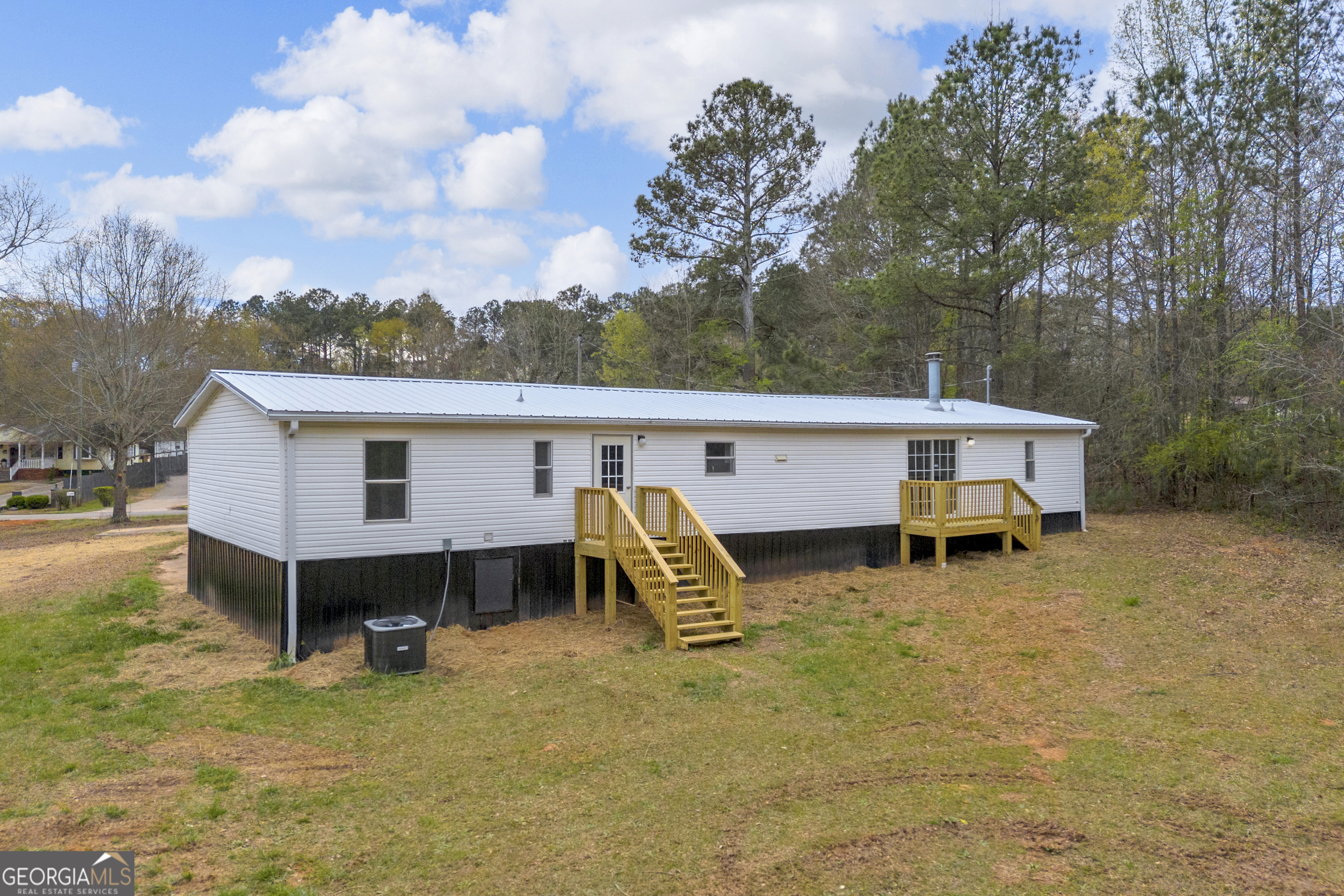 199 Alberta Drive Colbert, GA 30628 - Photo 37 of 39 a view of a patio with table and chairs with wooden fence and floor