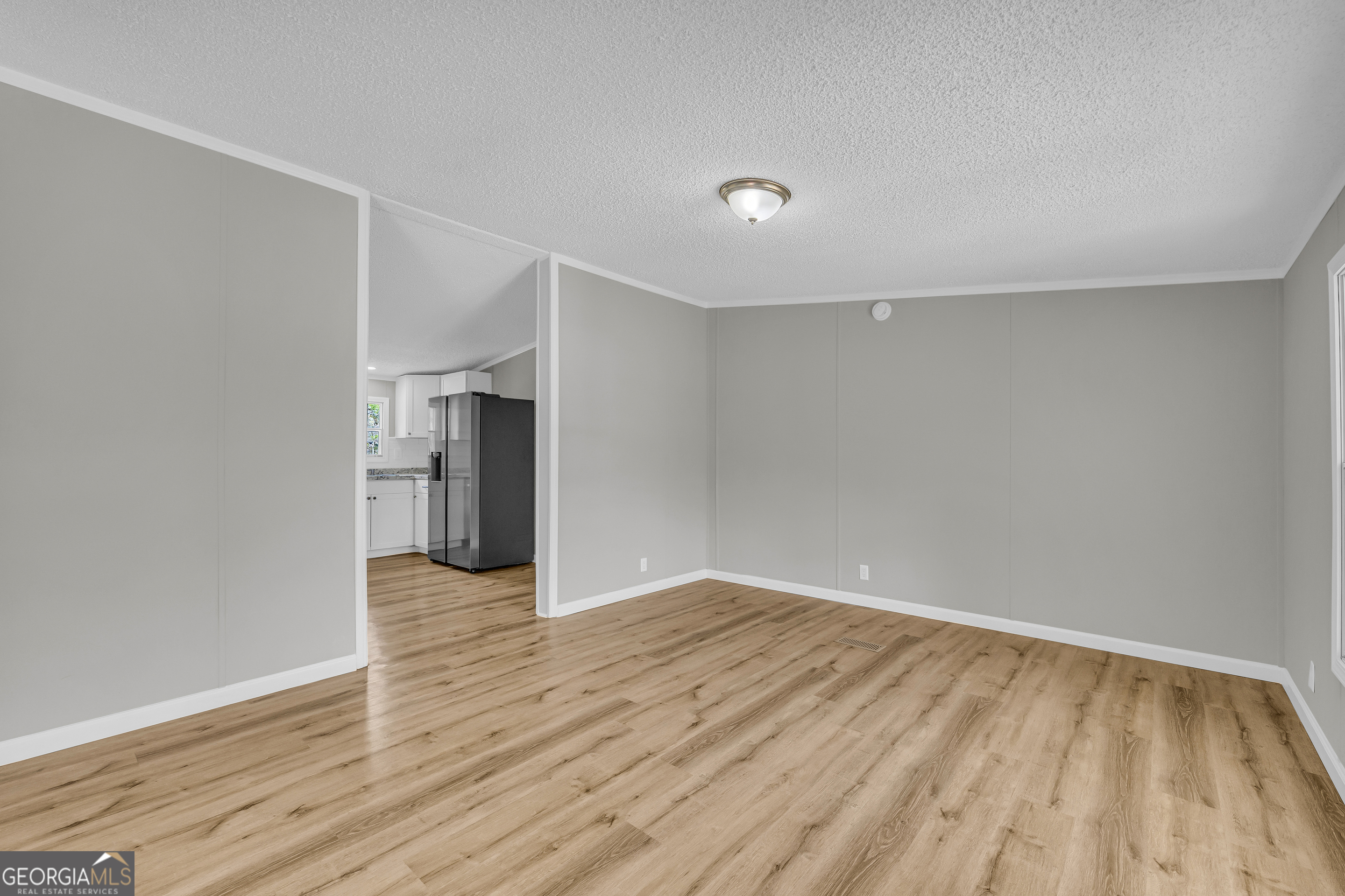 199 Alberta Drive Colbert, GA 30628 - Photo 9 of 39 a view of an empty room with wooden floor and closet