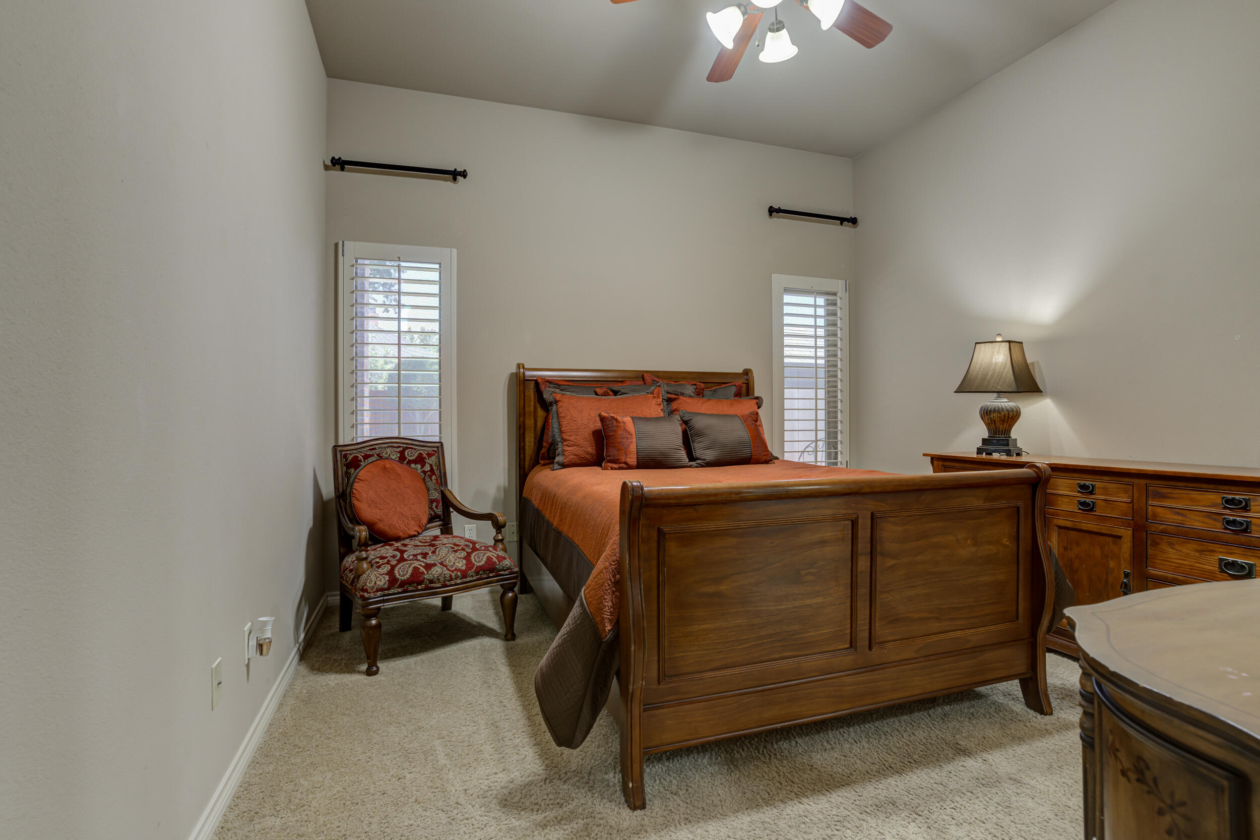 6008 89th Street Lubbock, TX 79424 - Photo 40 of 61 a bedroom with a bed and a chandelier