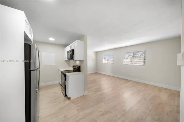 a kitchen with refrigerator and window