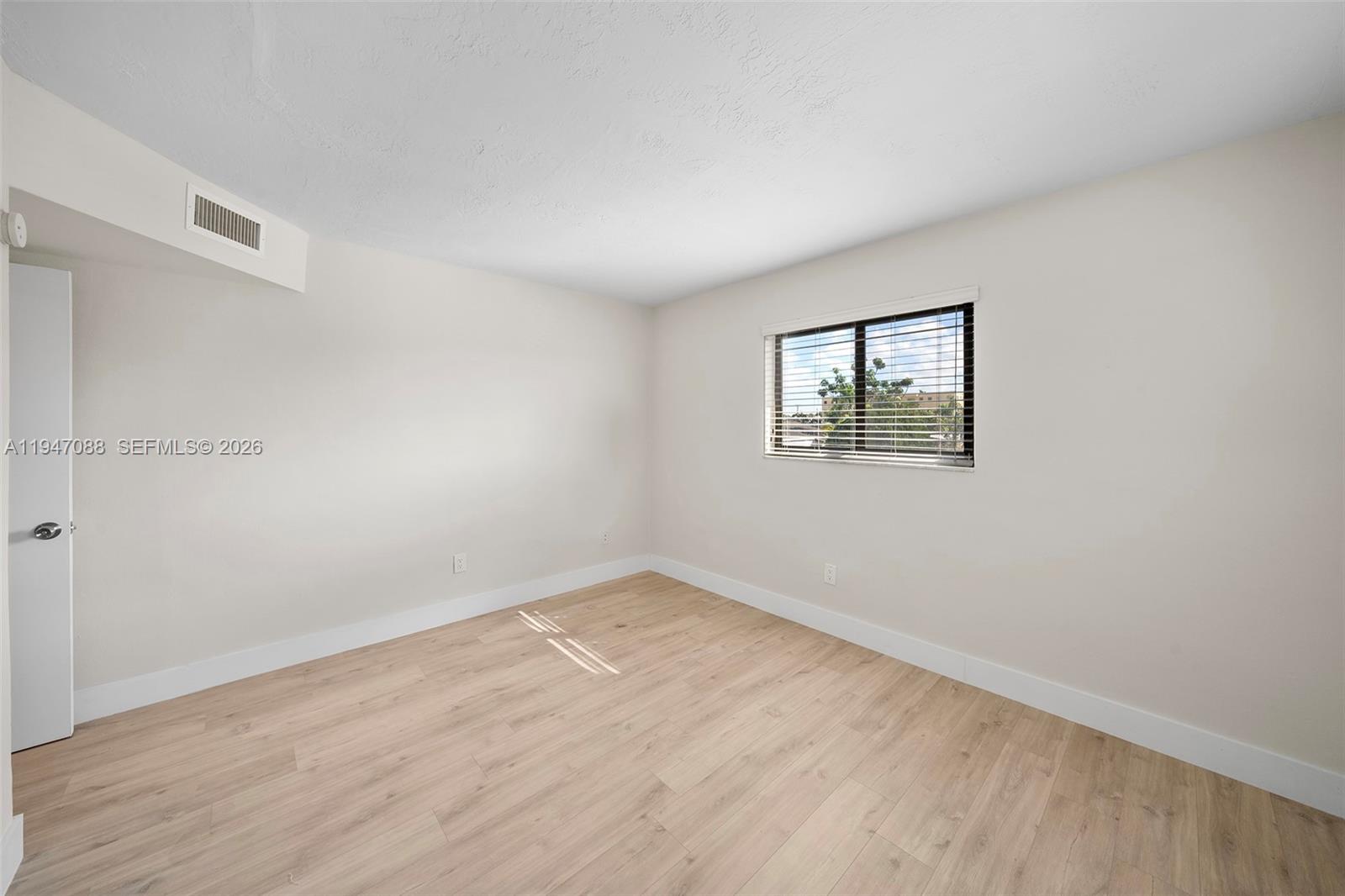 1330 West 29th Street, Unit 35 Hialeah, FL 33012 - Photo 5 of 16 an empty room with a window