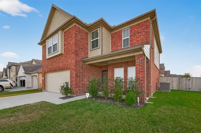 a dining room with furniture a chandelier and wooden floor