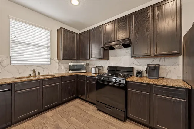 a view of a house with a big yard and a large tree