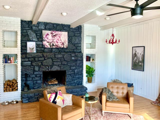 a living room with furniture a flat screen tv and a fireplace