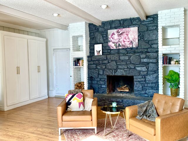 a living room with furniture a flat screen tv and a fireplace