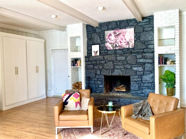 a living room with furniture a flat screen tv and a fireplace