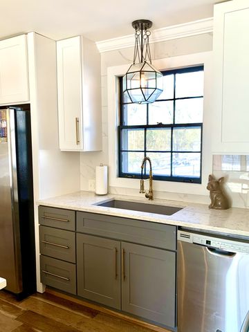 a kitchen with stainless steel appliances granite countertop a sink and a window