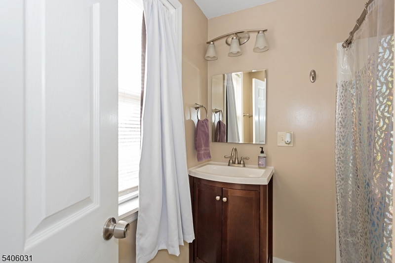 826 Sigsbee Avenue Alpha, NJ 08865 - Photo 11 of 38 a bathroom with a sink and a mirror