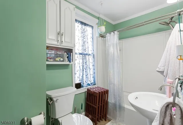 a bathroom with a sink mirror and toilet