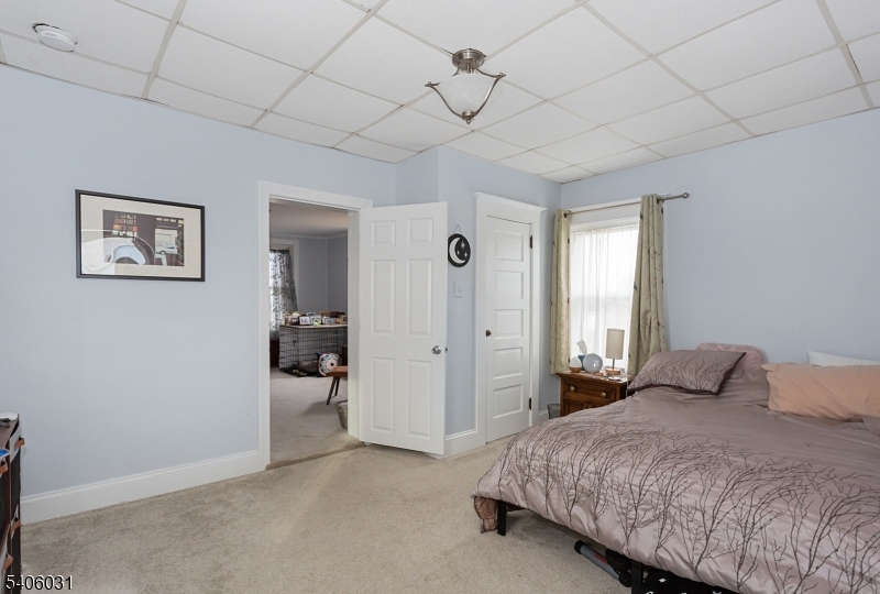 826 Sigsbee Avenue Alpha, NJ 08865 - Photo 19 of 38 a bedroom with a bed and a chandelier