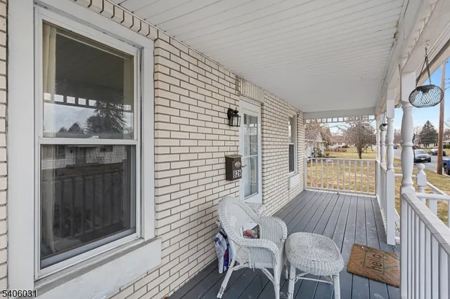 a view of a patio with table and chairs with wooden floor and fence