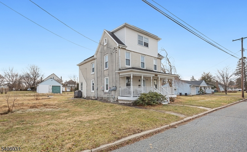 826 Sigsbee Avenue Alpha, NJ 08865 - Photo 29 of 38 a view of a white house with a large trees next to road