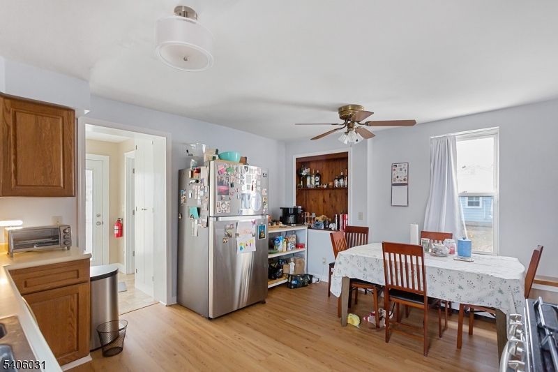 826 Sigsbee Avenue Alpha, NJ 08865 - Photo 7 of 38 a view of a dining room with furniture window and wooden floor