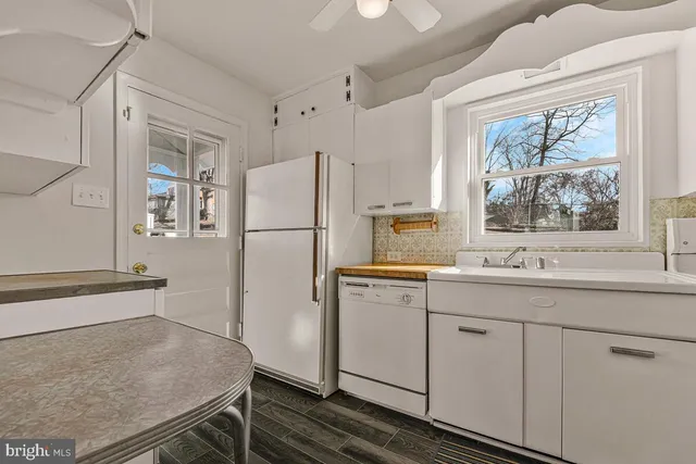 a kitchen with a refrigerator a sink and cabinets