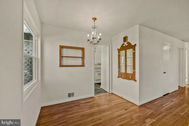 a view of a room with wooden floor and windows