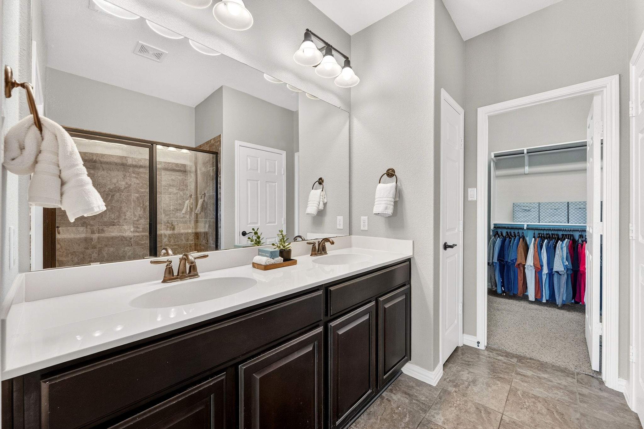 9932 Wading Pool Path Austin, TX 78748 - Photo 16 of 28 The ensuite experience is all about convenience and comfort. Enjoy the luxury of a dual-sink vanity with plenty of counter space for busy mornings.