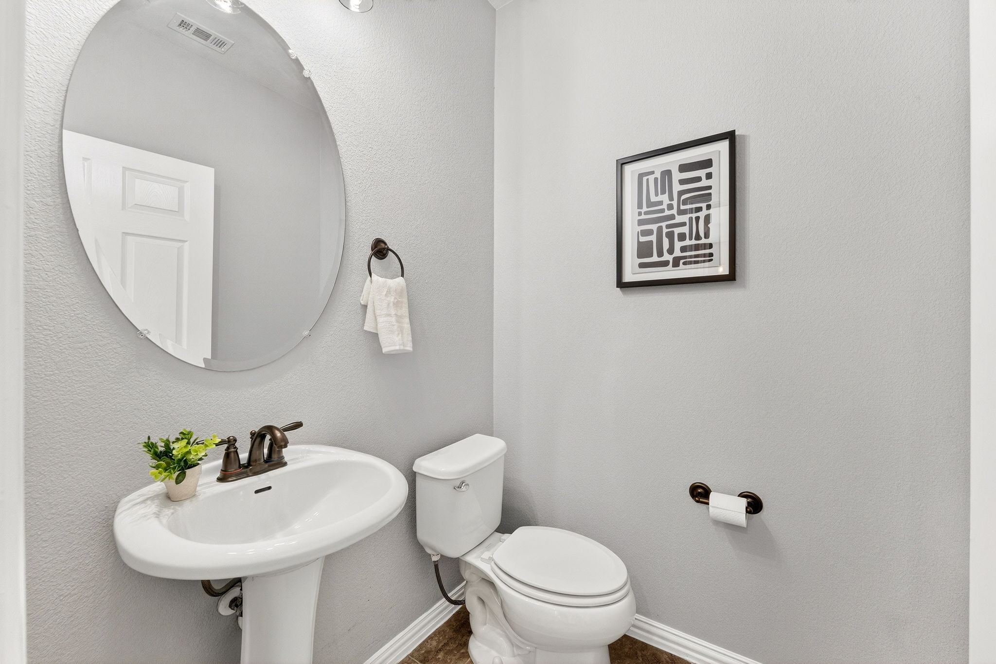 9932 Wading Pool Path Austin, TX 78748 - Photo 19 of 28 This powder room features a classic pedestal sink and clean, neutral tones.
