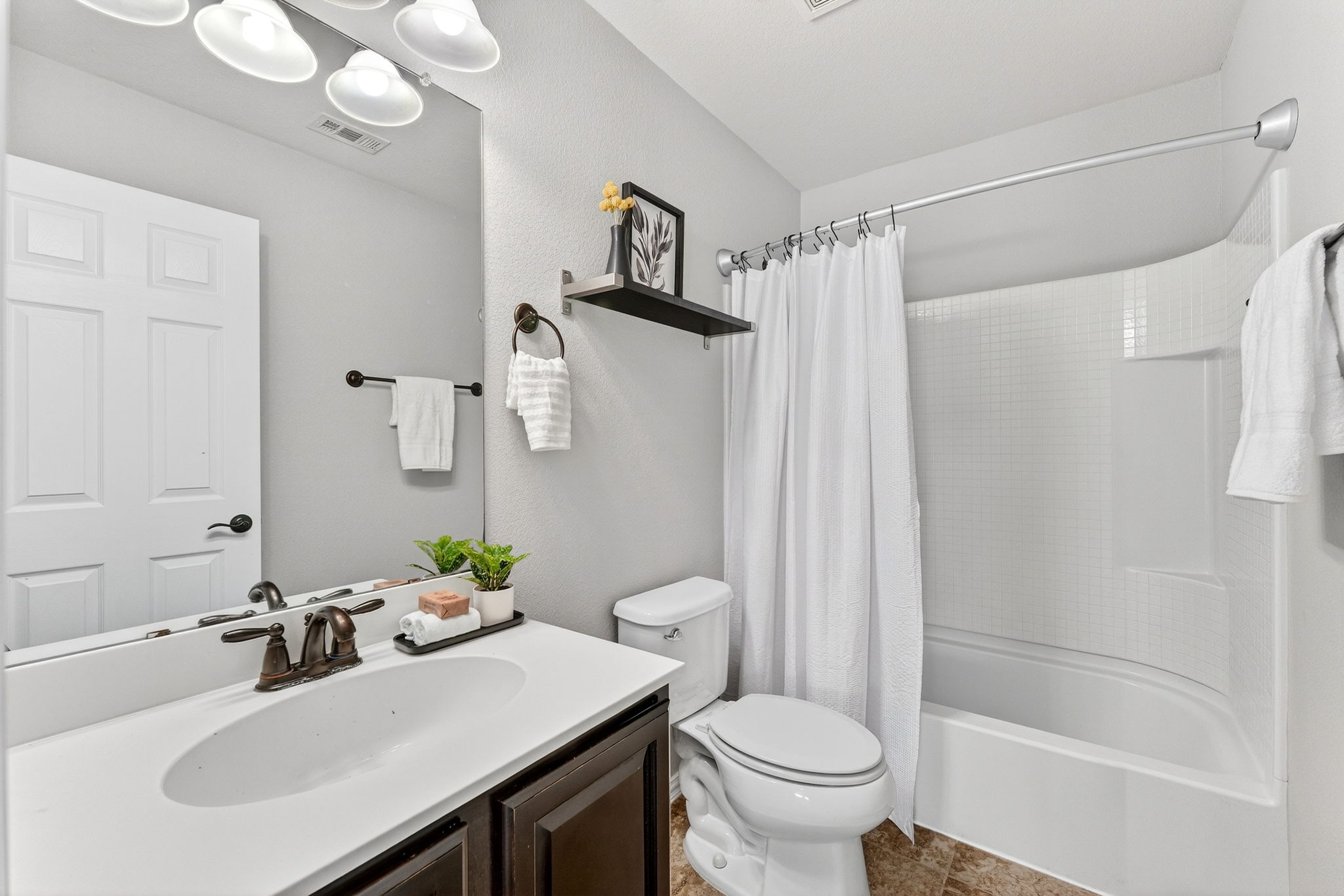 9932 Wading Pool Path Austin, TX 78748 - Photo 21 of 28 The secondary bathroom is designed with a clean, cohesive look that mirrors the rest of the home.