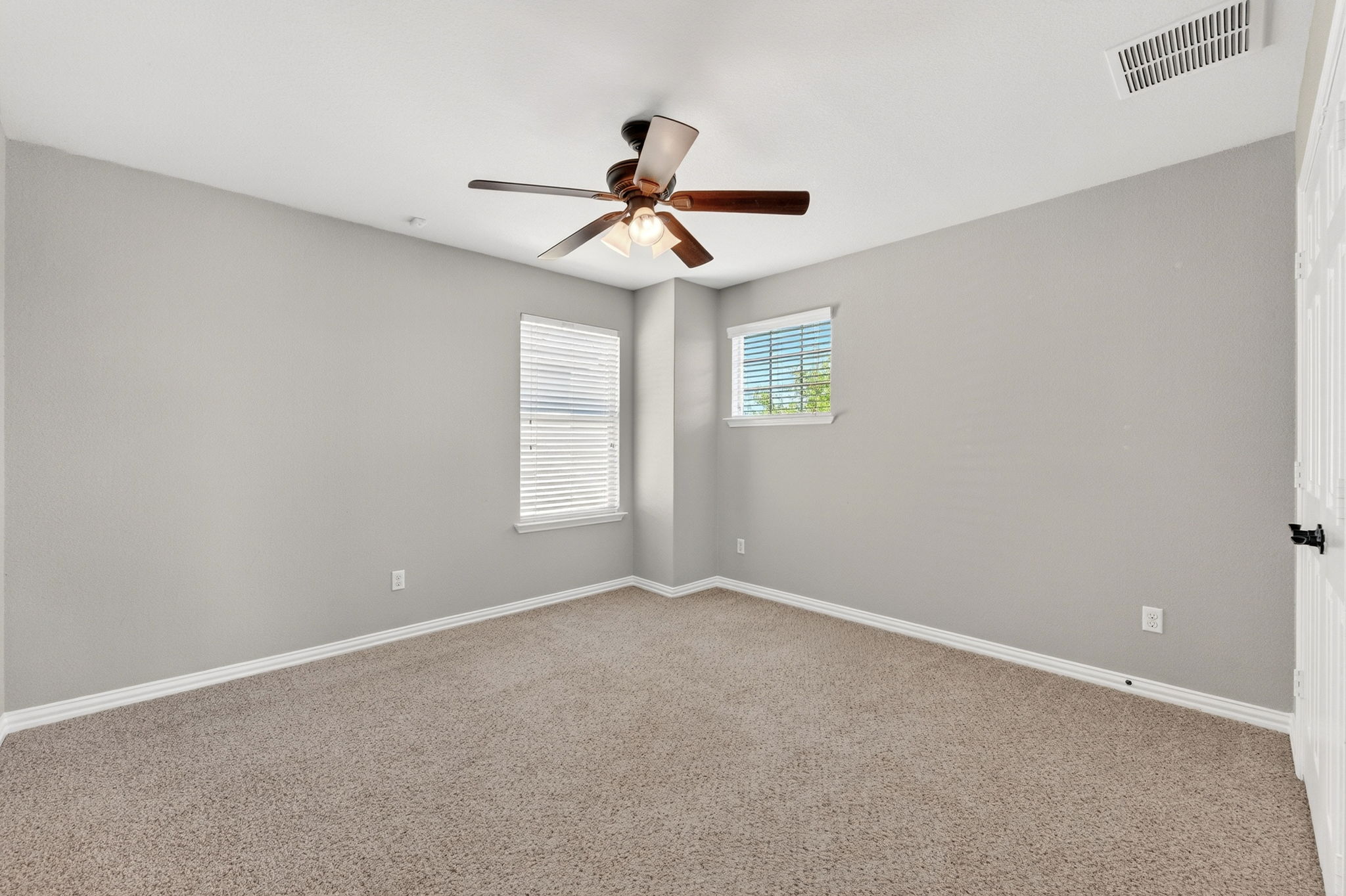 9932 Wading Pool Path Austin, TX 78748 - Photo 23 of 28 The neutral palette and plush carpeting create a warm, inviting atmosphere in this spacious bedroom.