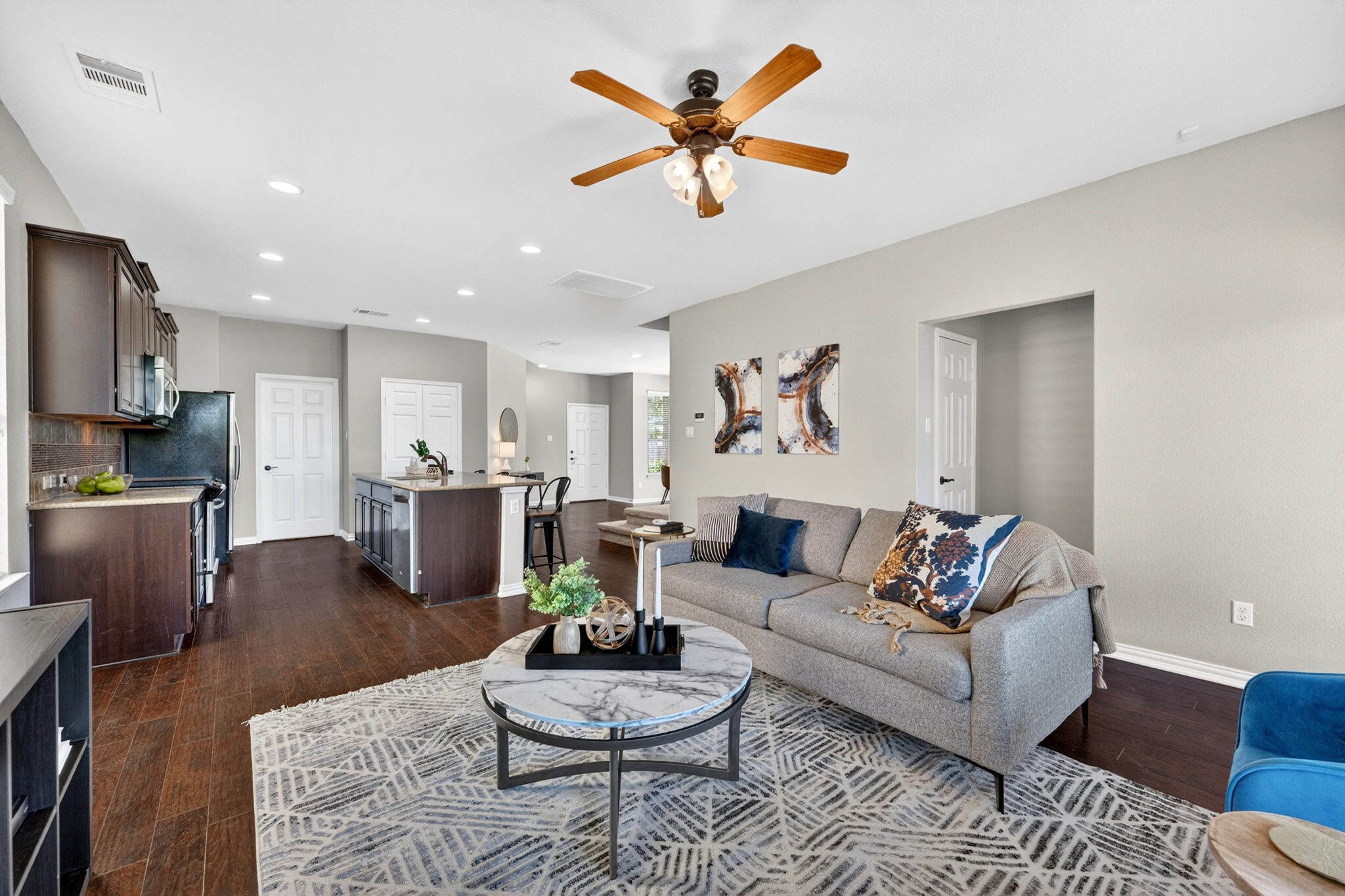 9932 Wading Pool Path Austin, TX 78748 - Photo 3 of 28 This is where life happens. The open-concept layout is a host’s dream, anchored by rich, espresso-toned flooring that ties it all together.