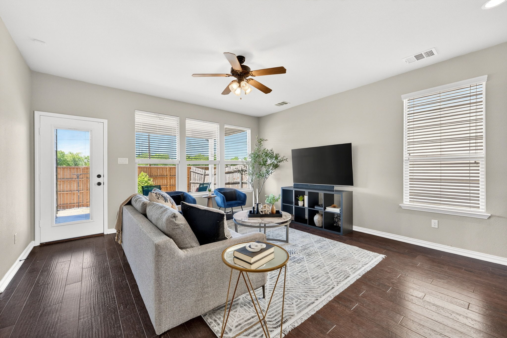 9932 Wading Pool Path Austin, TX 78748 - Photo 4 of 28 A trio of large windows floods the interior with natural light, offering a clear view of the private outdoor space.