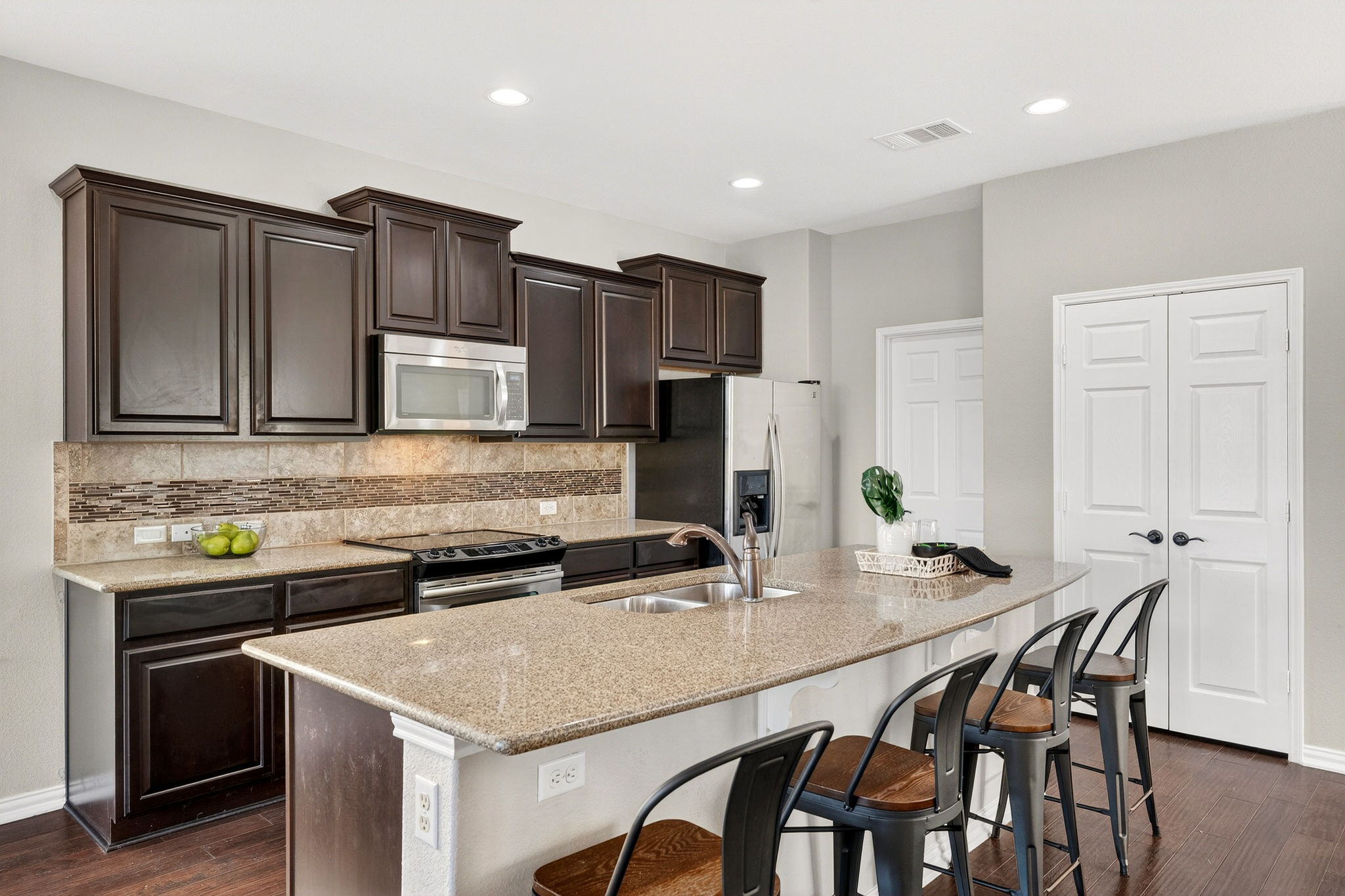 9932 Wading Pool Path Austin, TX 78748 - Photo 8 of 28 Note the designer tile backsplash; it's that extra bit of personality that sets this kitchen apart.