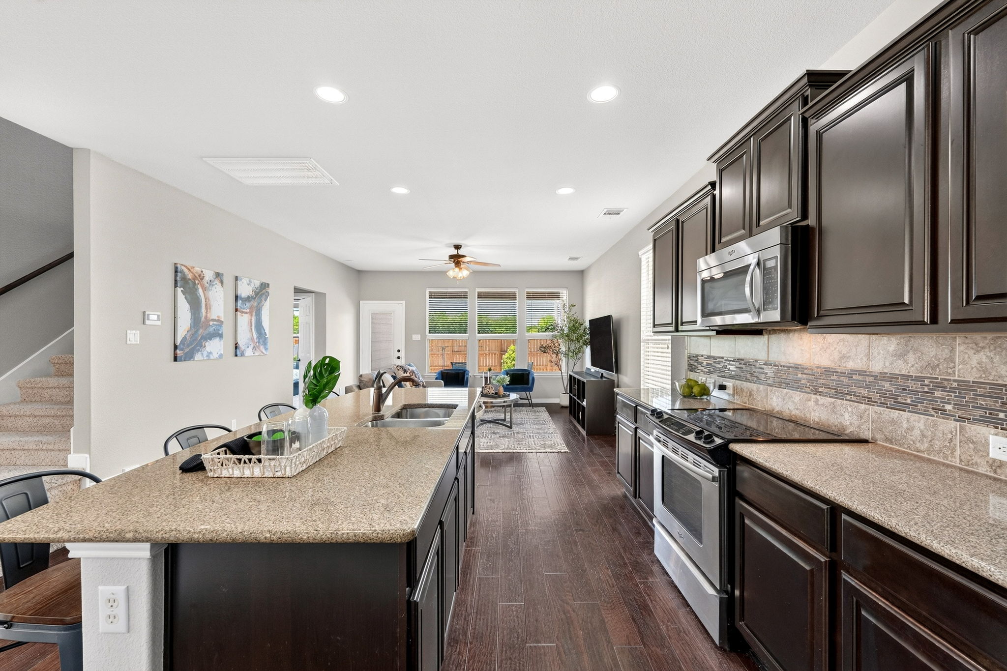 9932 Wading Pool Path Austin, TX 78748 - Photo 9 of 28 Standing at the sink you can see all the way to the backyard. It’s the perfect layout for keeping an eye on everyone while you get dinner started.