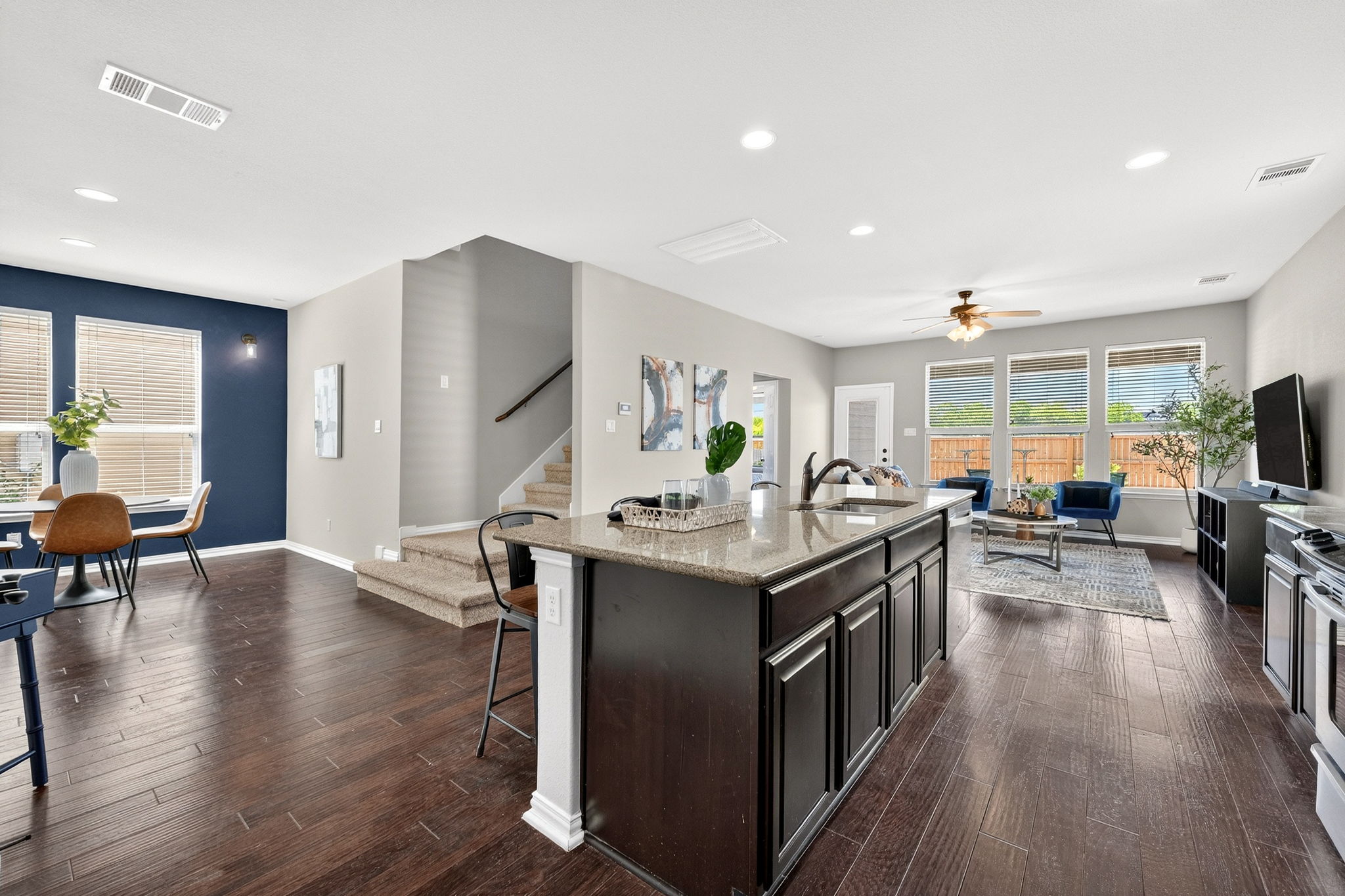 9932 Wading Pool Path Austin, TX 78748 - Photo 10 of 28 Everything connects here. The transition from the airy kitchen to the bold, navy accented dining nook to the comfortable living space.