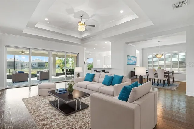 a living room with furniture potted plant and a large window
