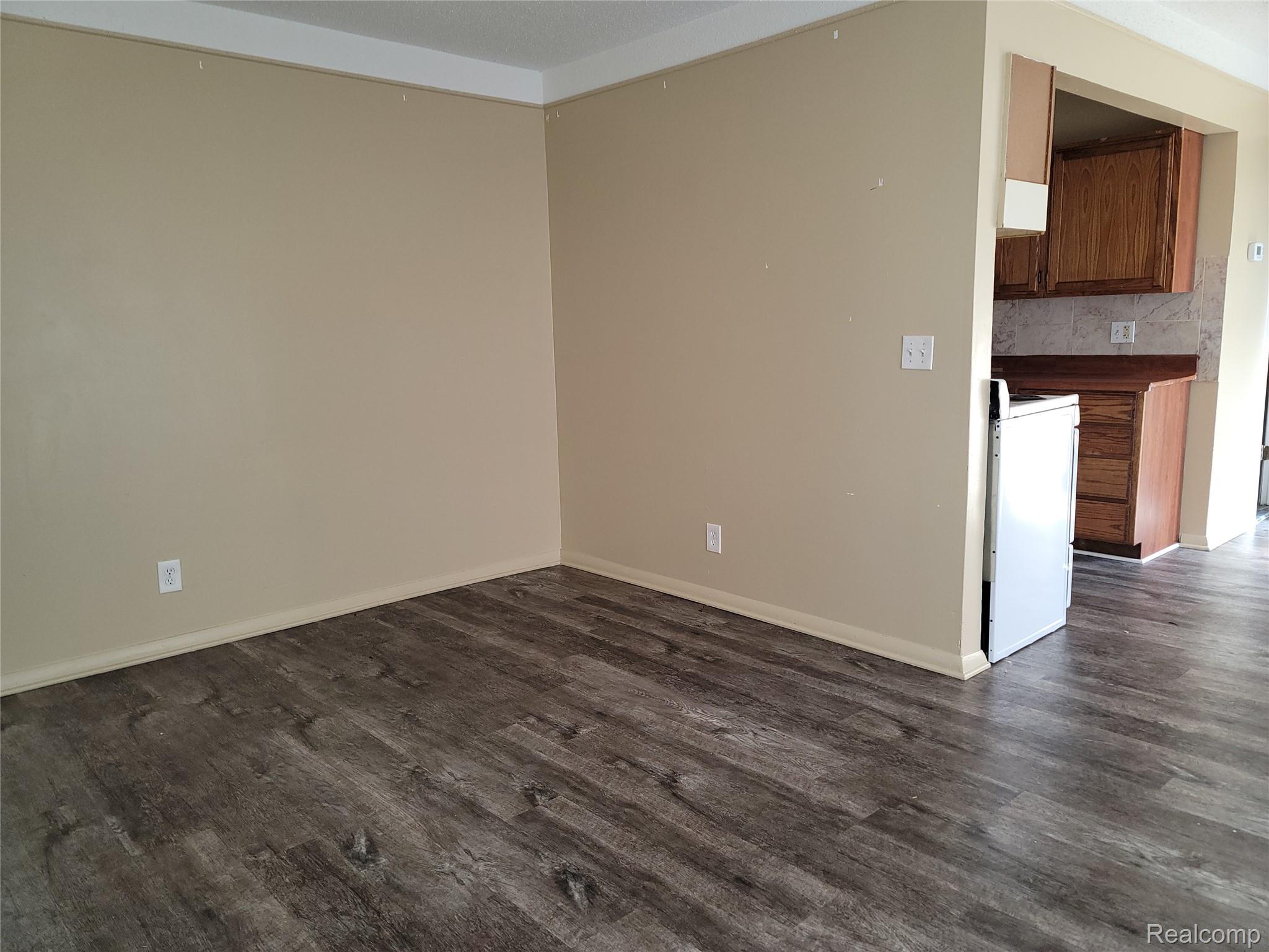 Spare room featuring dark wood finished floors