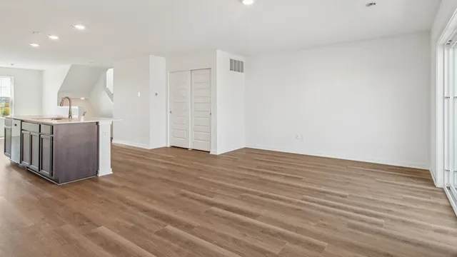a view of a kitchen with wooden floor