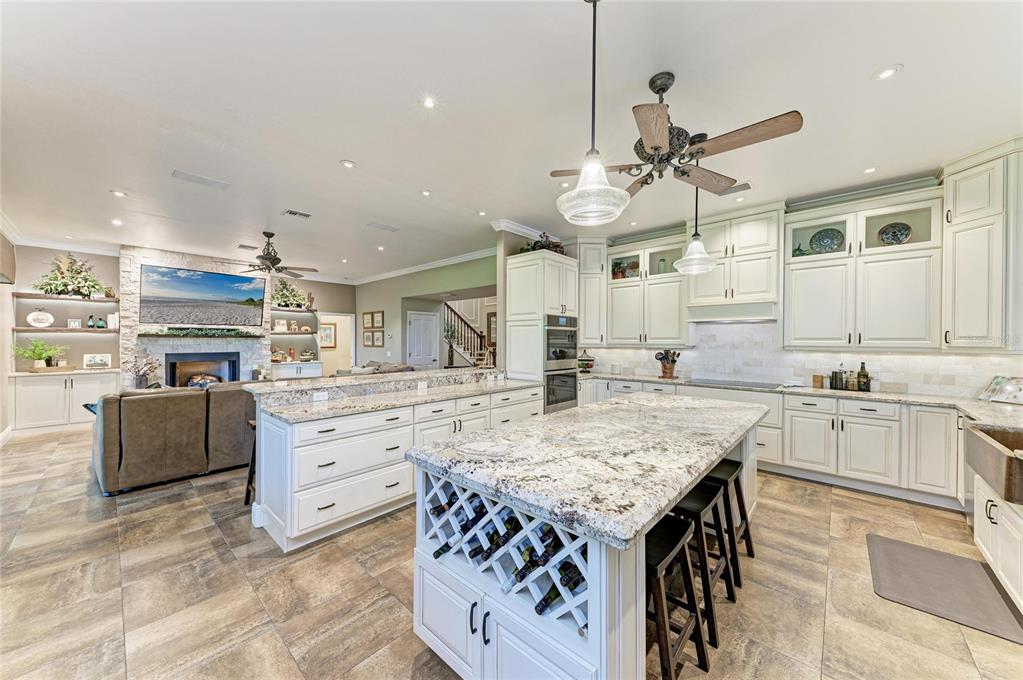 39321 Washington Loop Road Punta Gorda, FL 33982 - Photo 14 of 98 a kitchen with granite countertop a stove a sink a dining table and chairs