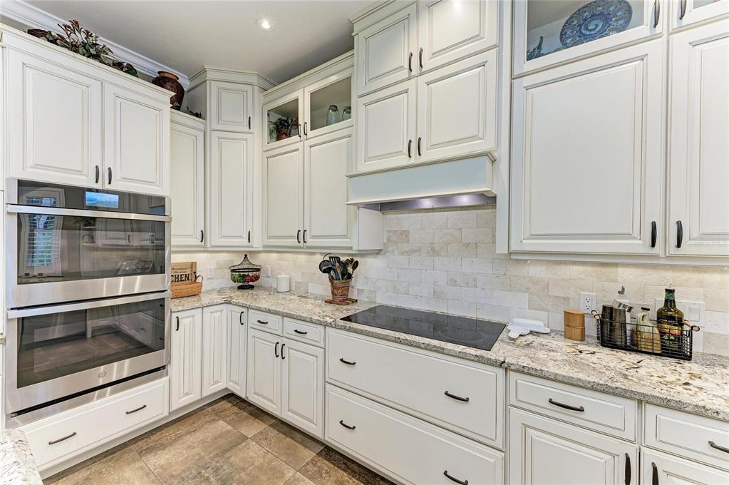 39321 Washington Loop Road Punta Gorda, FL 33982 - Photo 19 of 98 a kitchen with granite countertop white cabinets stainless steel appliances and sink