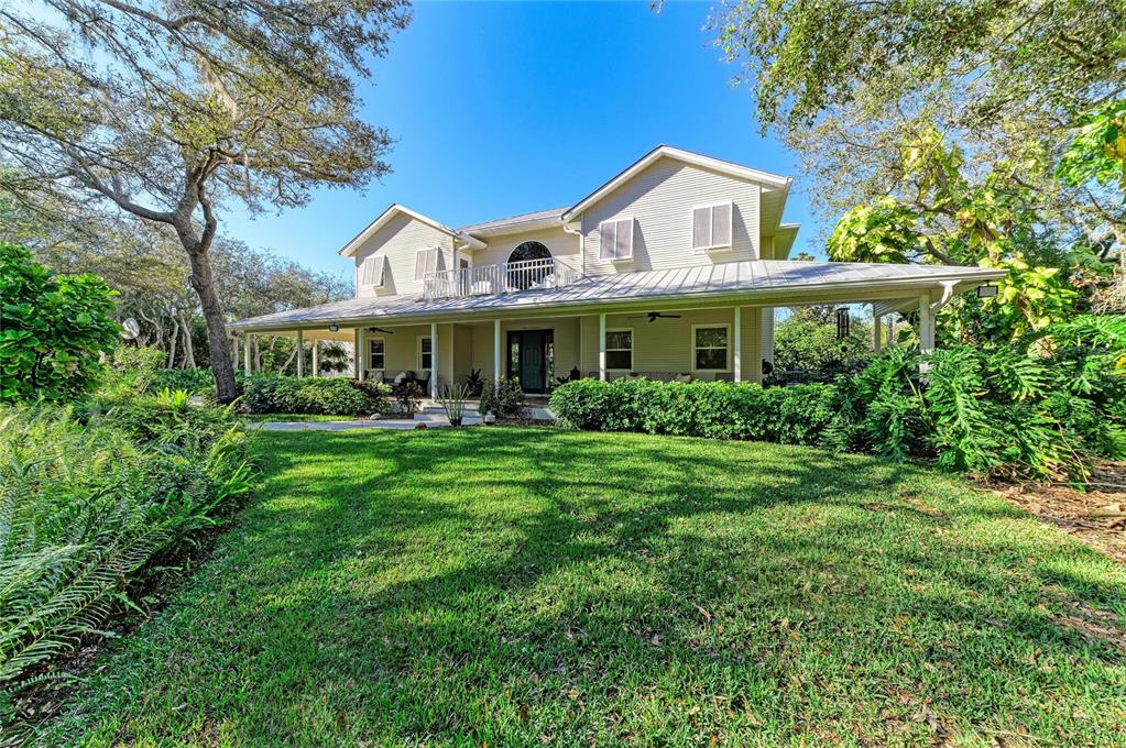 39321 Washington Loop Road Punta Gorda, FL 33982 - Photo 2 of 98 a front view of a house with a yard table and plants