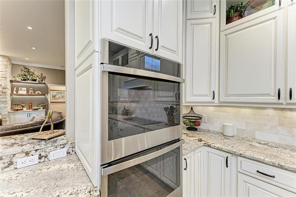 39321 Washington Loop Road Punta Gorda, FL 33982 - Photo 21 of 98 a kitchen with granite countertop a sink and cabinets
