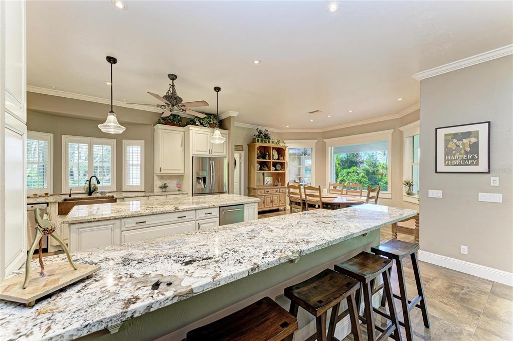 39321 Washington Loop Road Punta Gorda, FL 33982 - Photo 23 of 98 a dining hall with stainless steel appliances granite countertop a kitchen island a stove and a sink