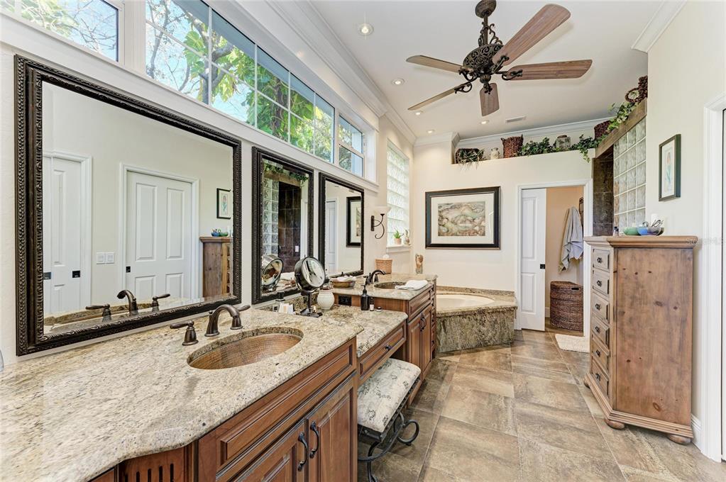 39321 Washington Loop Road Punta Gorda, FL 33982 - Photo 39 of 98 a bathroom with a granite countertop sink a mirror and shower