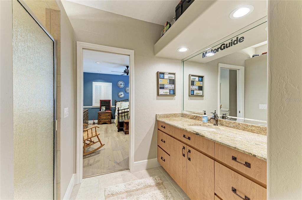 39321 Washington Loop Road Punta Gorda, FL 33982 - Photo 52 of 98 a spacious bathroom with a granite countertop sink mirror and vanity