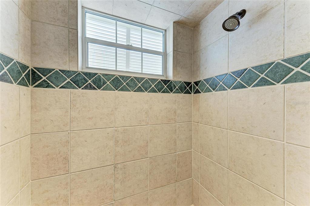 39321 Washington Loop Road Punta Gorda, FL 33982 - Photo 58 of 98 a bathroom with a window and a shower