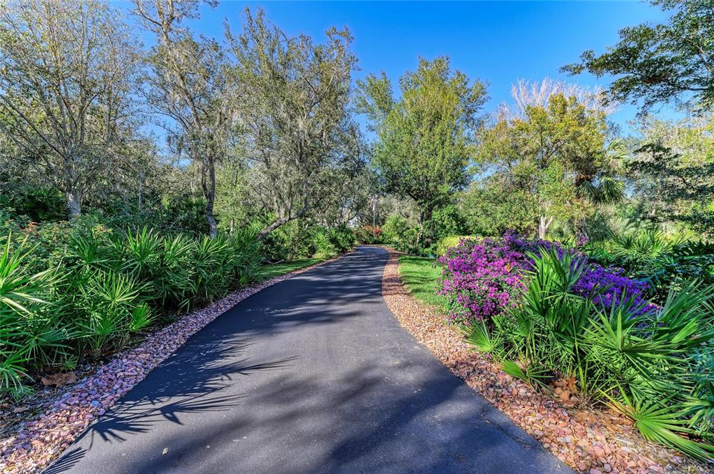39321 Washington Loop Road Punta Gorda, FL 33982 - Photo 85 of 98 a view of a pathway with a flower garden