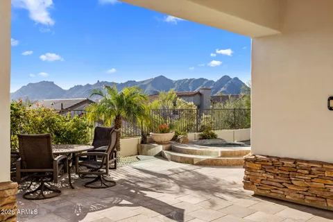 a view of a patio with a table and chairs and potted plants