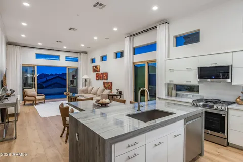 a kitchen with stainless steel appliances kitchen island granite countertop a sink and cabinets