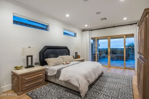 a bedroom with a bed and a mirror