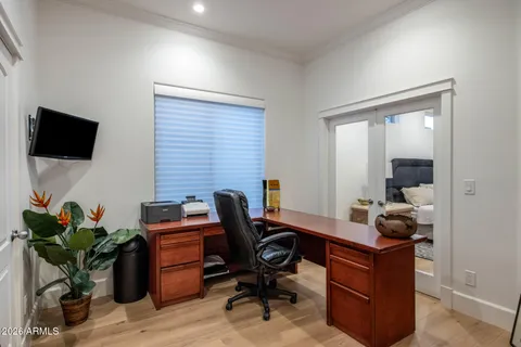 a work room with furniture and a potted plant