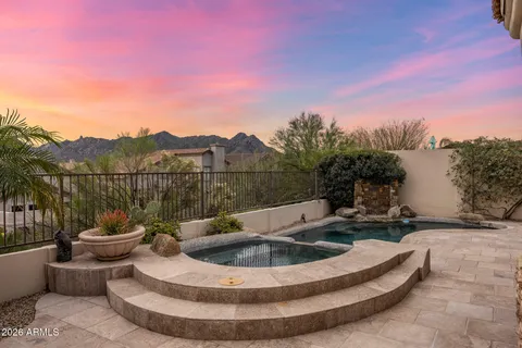 an aerial view of house with yard and mountain view in back