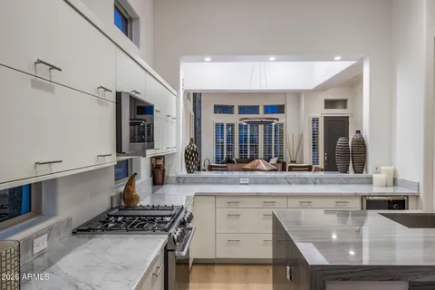 a kitchen with stainless steel appliances granite countertop a stove and a sink