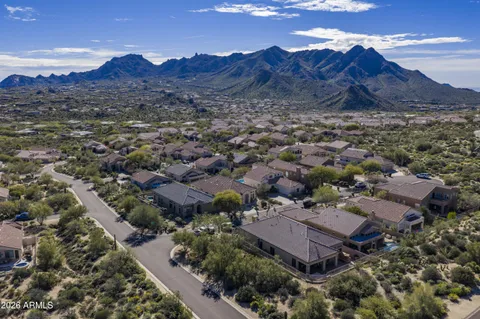an aerial view of residential house and sandy dunes