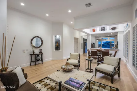 a living room with furniture a rug and a chandelier