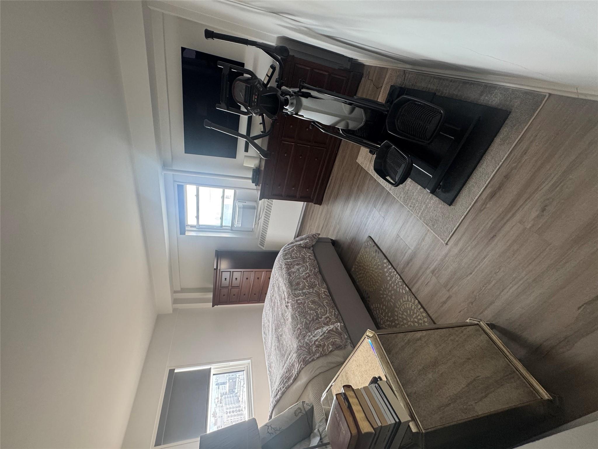 9 Fordham Hill Ovl, Unit 17C Bronx, NY 10468 - Photo 6 of 16 Bedroom featuring hardwood / wood-style flooring and radiator heating unit