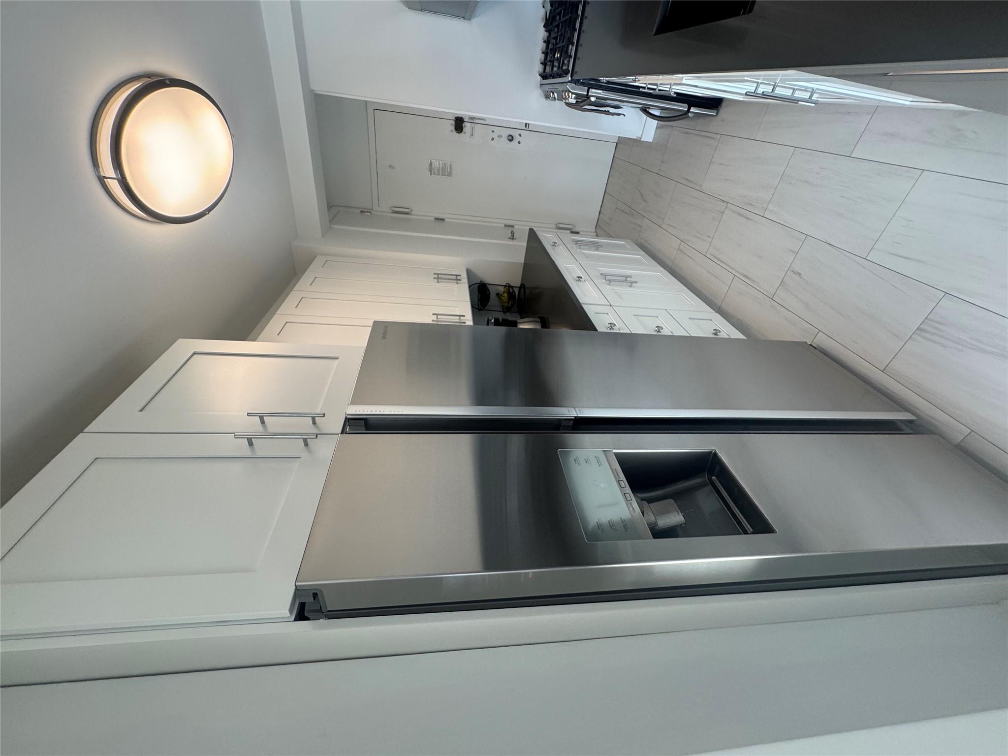9 Fordham Hill Ovl, Unit 17C Bronx, NY 10468 - Photo 8 of 16 Kitchen featuring range, white cabinets, and stainless steel refrigerator